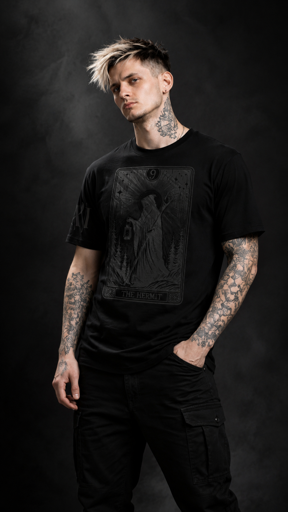 Man wearing a black t-shirt with a graphic design on a dark background