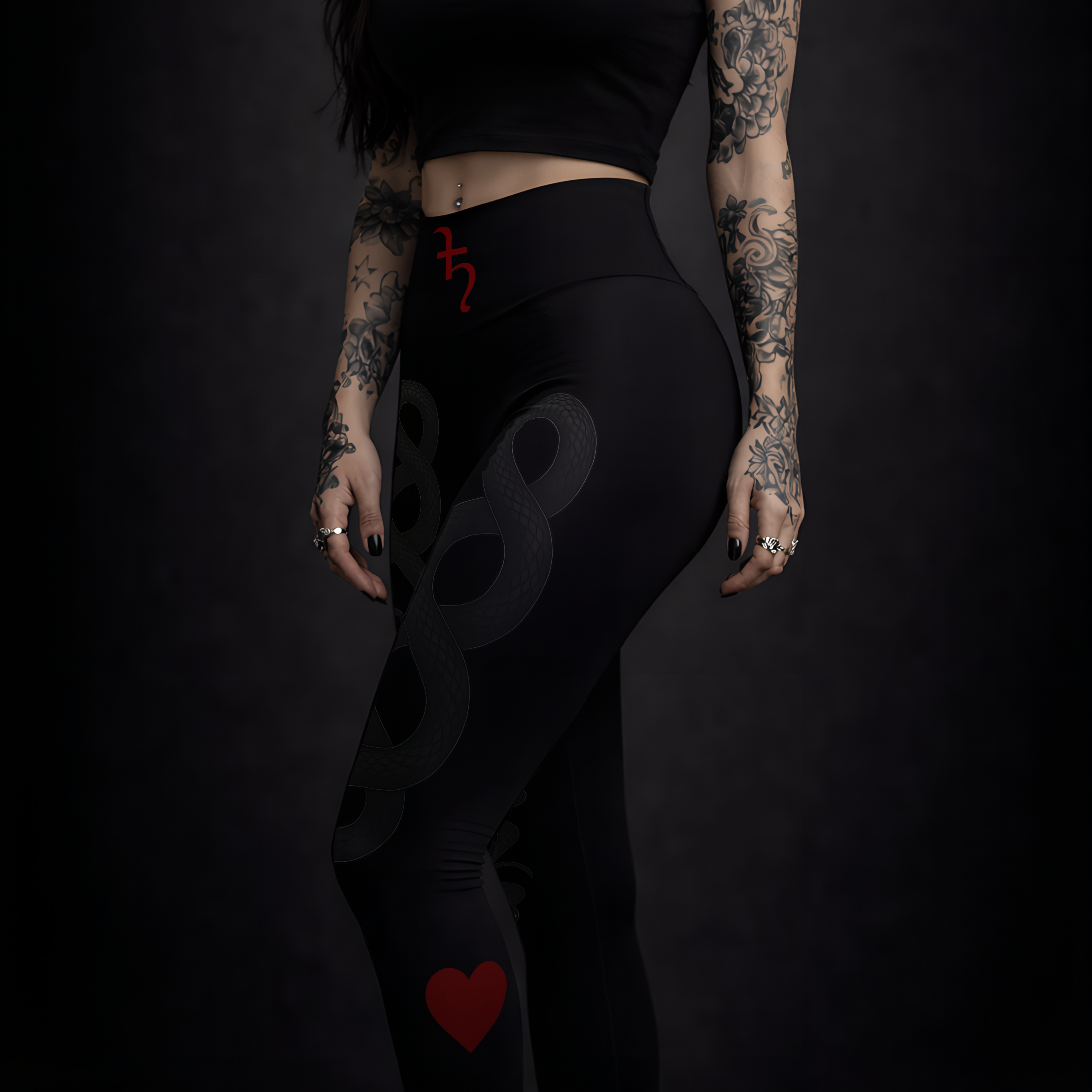 Woman in black outfit with tattoos and red heart designs on a dark background