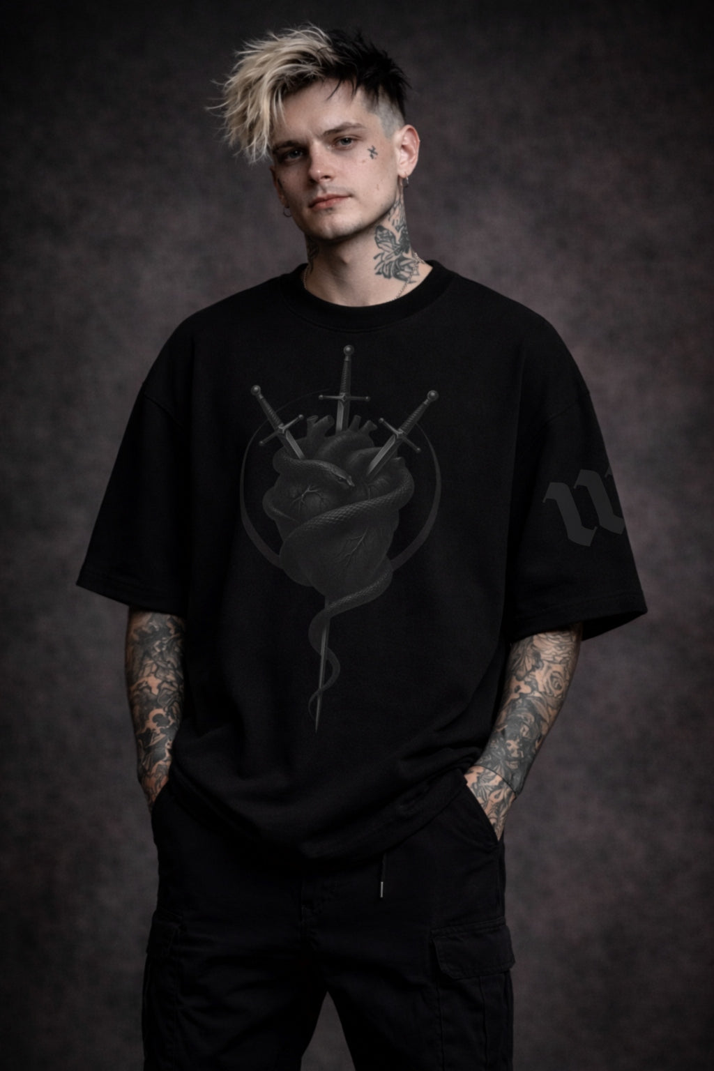 Person wearing a black t-shirt with a graphic design on a dark background