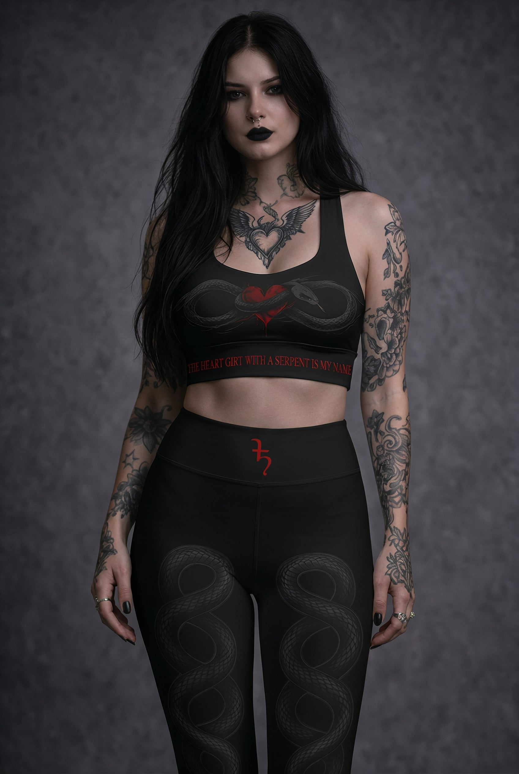 Woman wearing black athletic wear with red text and designs against a dark background